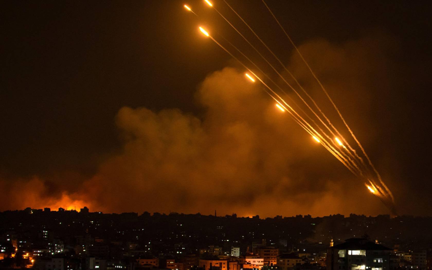 Rockets are fired toward Israel from the Gaza Strip, Sunday 8 October 2023.