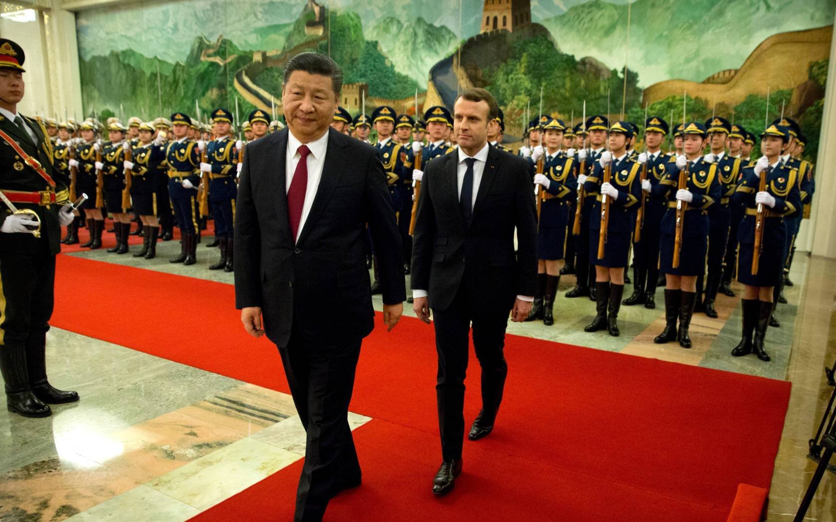 Chinese President Xi Jinping, left, and French President Emmanuel Macron review a Chinese guard of honour during a welcome ceremony at the Great Hall of the People in Beijing.